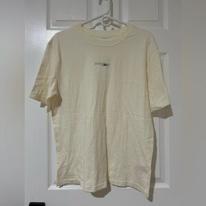 New large UP Urban Outfitters cream colored large T between the lines ambiguous